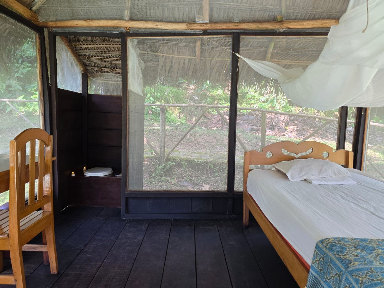 Private tambo interior with bed and mosquito net at Dreamglade